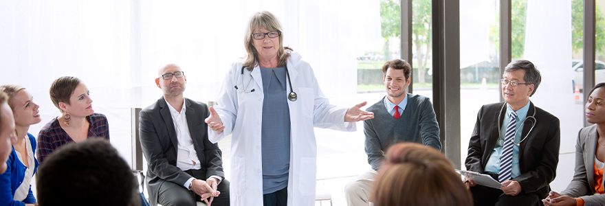 physician standing teaching engaged learners